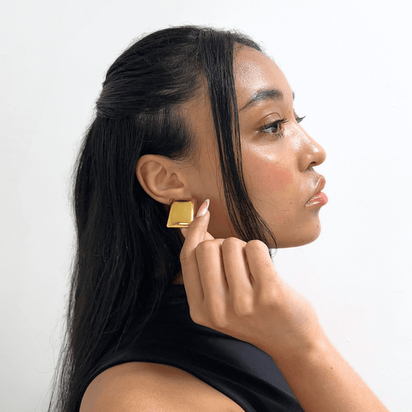 Woman wearing Alvéra Gold Square Stud Earrings – elegant gold-plated studs, classy minimalist jewelry for everyday wear